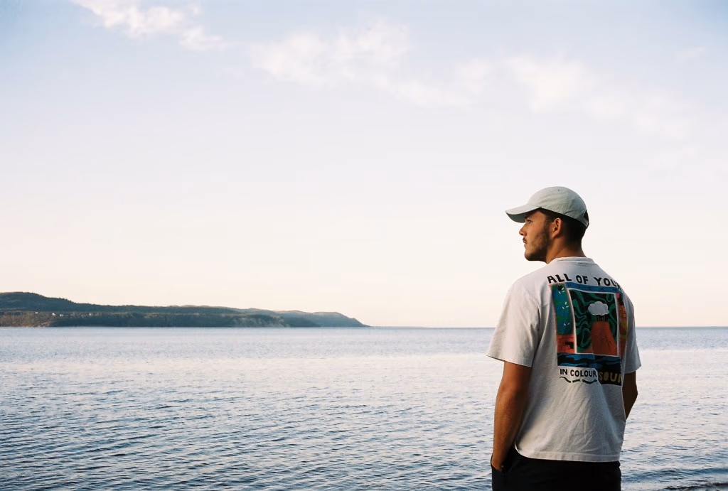 Face au Large, self-portrait from behind facing the St. Lawrence horizon in Gaspésie, Kodak Portra 400