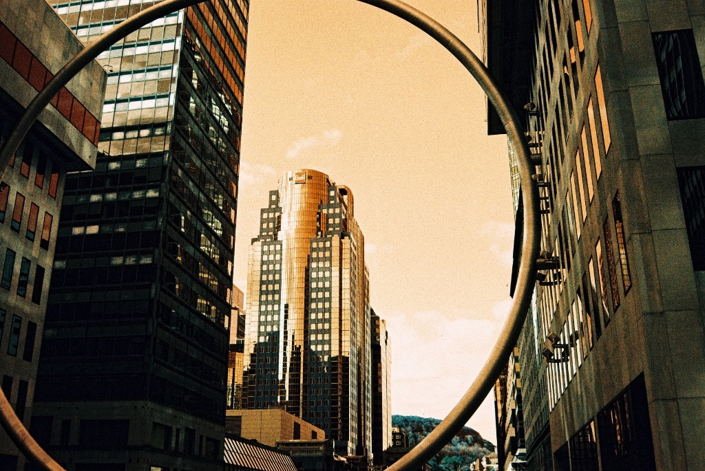 Place Ville Marie giant ring framing a skyscraper against an orange sky.