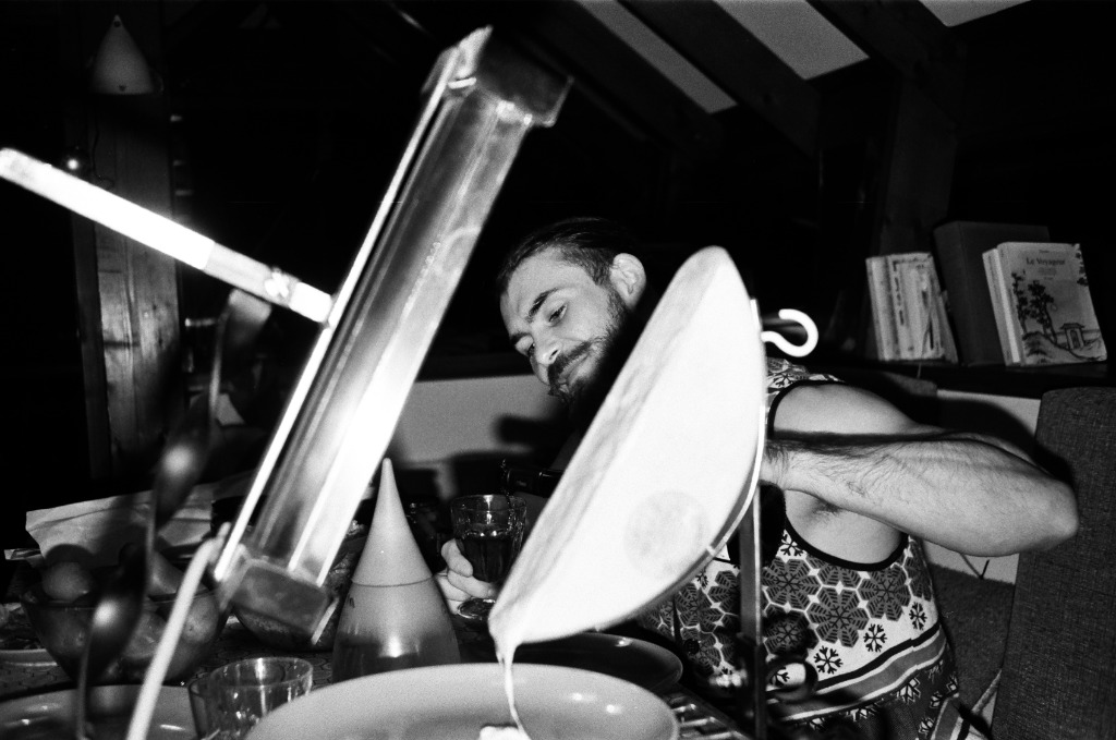 Close-up of a raclette meal with vintage camera in foreground.