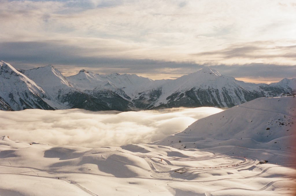 Snowpark streaks at sunset, soft texture resembling icing sugar.