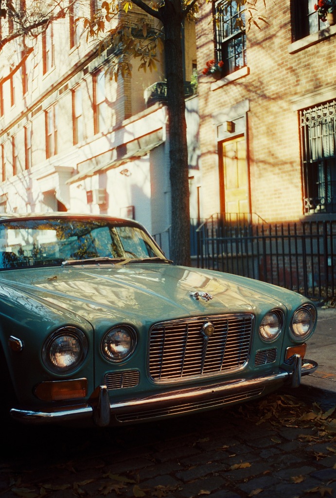 Blue Jaguar parked on a cobbled street in SoHo.